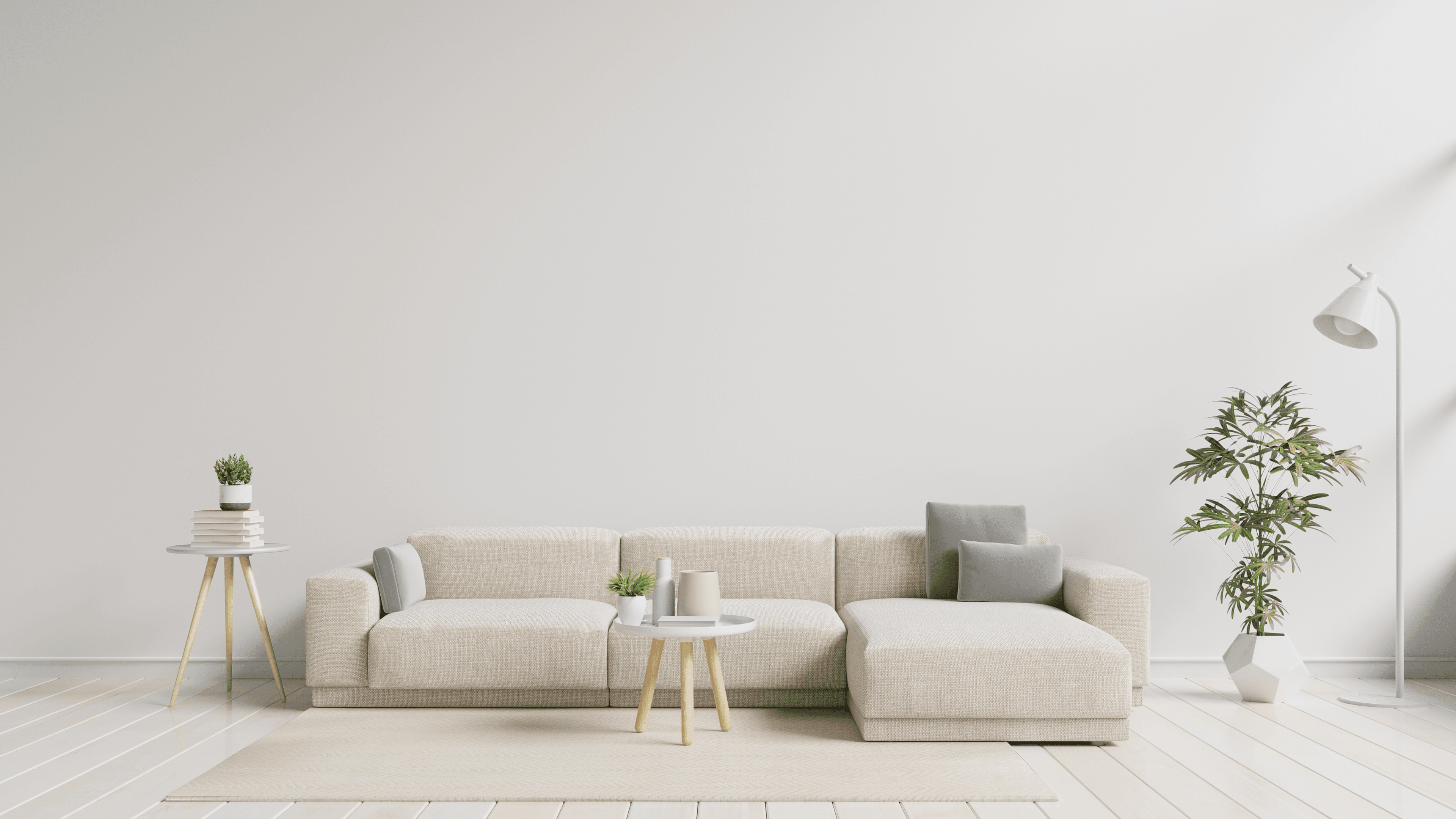 A calm neutral living room with a light sofa and timber side table